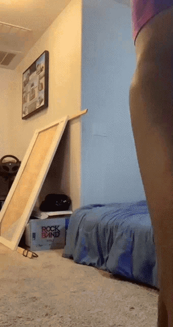 a person standing in a room with a box that says rock band