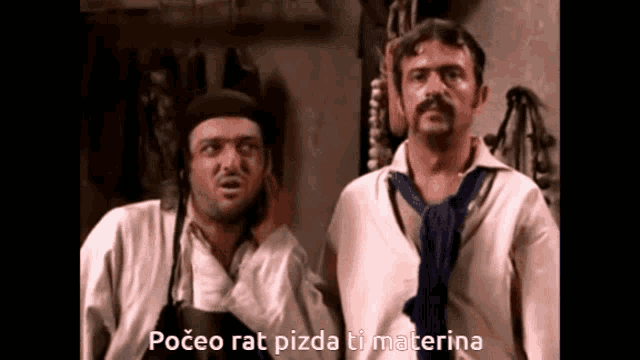 two men standing next to each other with the words " poceo rat pizda ti materina " below them