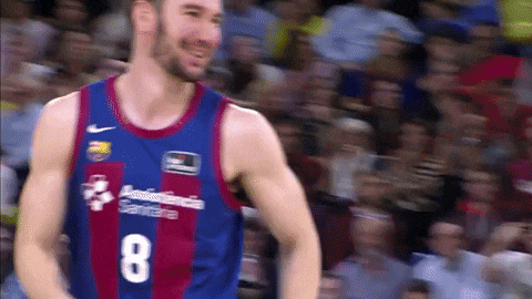 a basketball player with the number 8 on his jersey is smiling