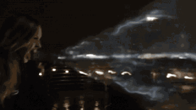 a blurry picture of a person standing in front of a large explosion