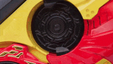 a close up of a red and yellow toy car with a speaker in the middle .