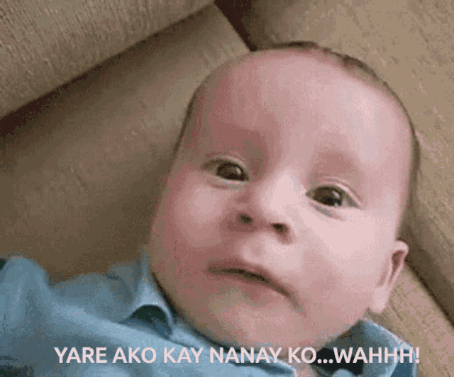 a baby laying on a couch with the words yare ako kay nanay ko