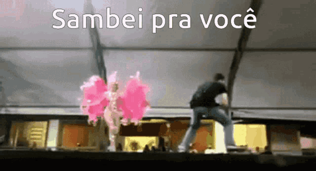 a man is standing next to a woman with pink wings and the words " sambei pra voce "