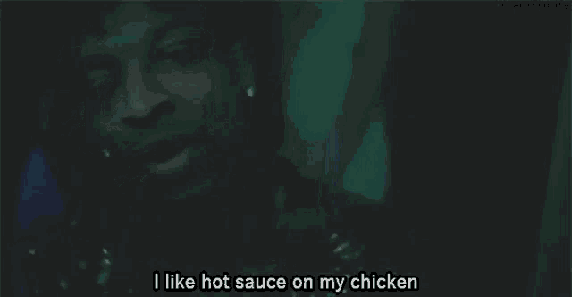 a man is talking about hot sauce on his chicken .