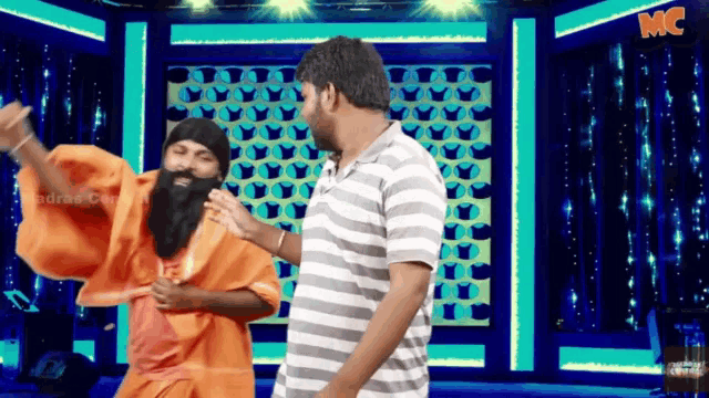 a man with a beard is standing next to another man in a striped shirt with the word mc on the bottom