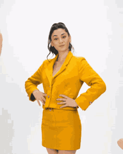 a woman wearing sunglasses and a yellow suit
