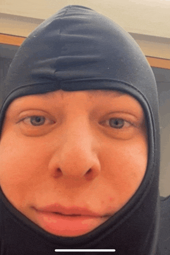 a close up of a person wearing a hood