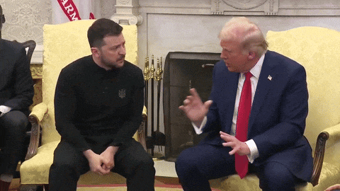 two men are sitting on a couch and one of them is wearing a shirt that says ukraine