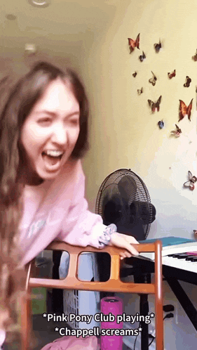 a girl in a pink pony club shirt is laughing