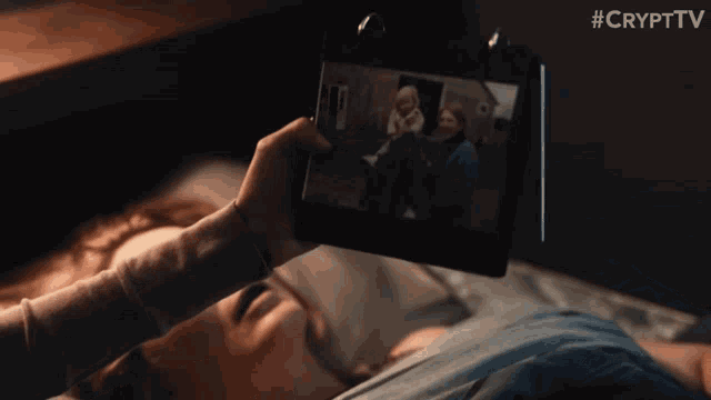 a person taking a picture of a woman with the hashtag #cryptv