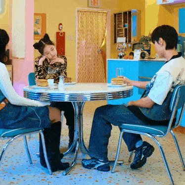 people sitting at a table with pancakes and a sign that says exit on it