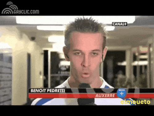 a man with a microphone in front of a sign that says " benoit pedretti "