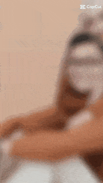 a blurred image of a person with a capcut logo on the bottom