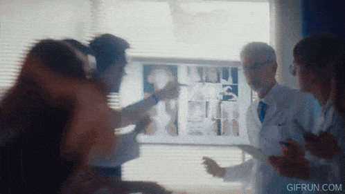 a group of doctors are looking at an x-ray of a patient