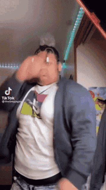 a man wearing a white shirt and a blue jacket is dancing .
