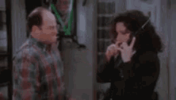 a man and a woman are talking on a cell phone .