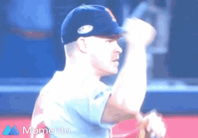 a baseball player throws a ball with the word momento in the corner