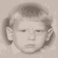 a close up of a young boy 's face with a circle on his forehead