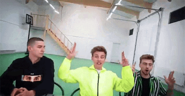 a group of young men are standing next to each other in a room .