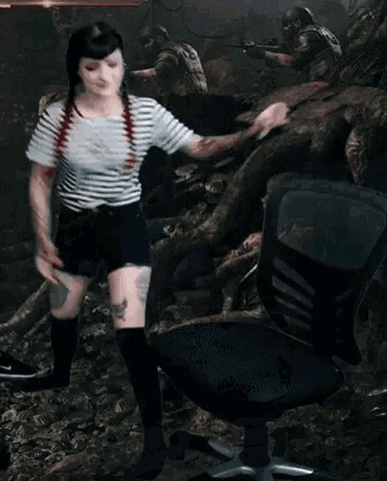 a woman in a striped shirt sits in a chair with the letter t on the back