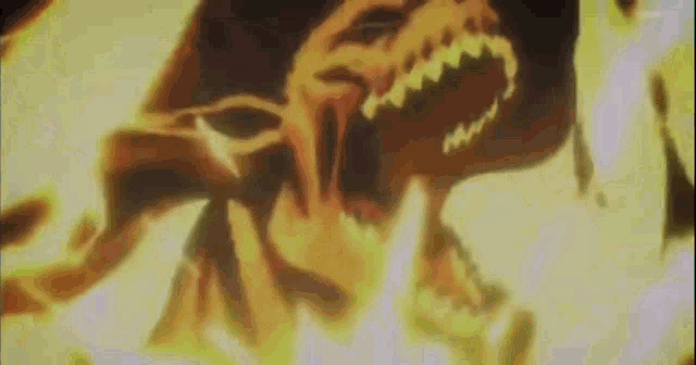 a close up of a monster 's face with its mouth open in a fire .