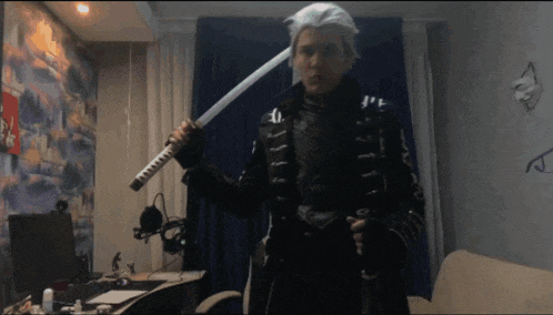 a man is holding a sword in a room