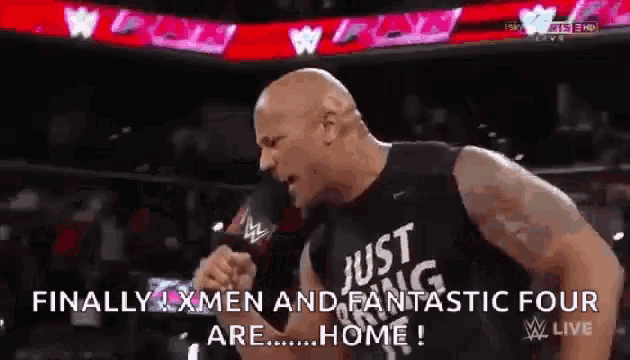 a man wearing a black shirt that says just amazing is standing in front of a crowd