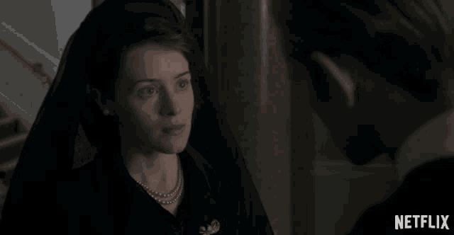 a woman in a black cape says thank you to a man