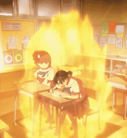 two girls are sitting at desks in a classroom with a bulletin board that says ' chinese ' on it