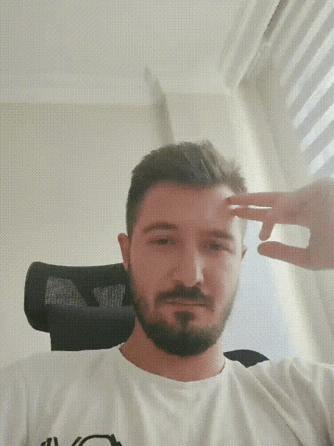 a man with a beard is wearing a white shirt that says ' a ' on the front