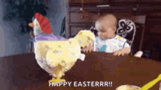 a baby is sitting at a table with a stuffed chicken and a toy chicken .