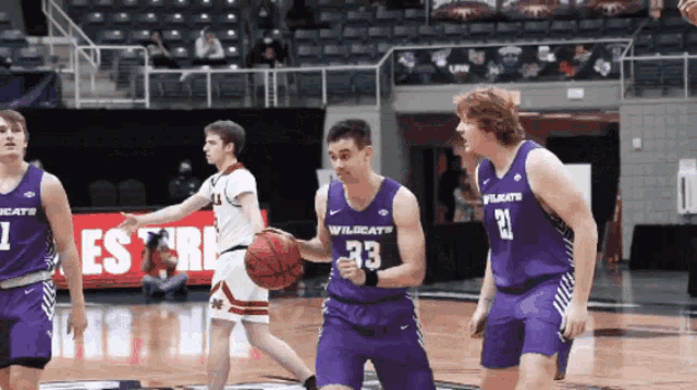 a basketball player with the number 33 on his jersey dribbles the ball