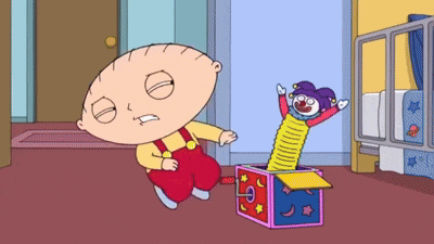 a cartoon character named stewie is standing next to a box with a clown in it