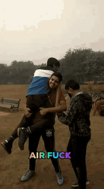 a man is carrying another man in his arms with the words air fuck written below him
