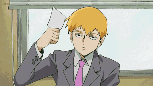 a man in a suit and tie holds a piece of paper over his head