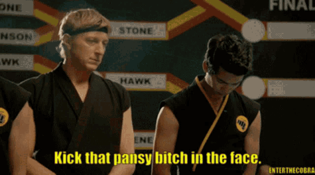 a man in a karate uniform says " kick that pansy bitch in the face " while standing next to another man