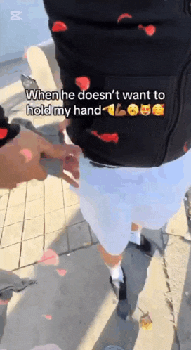 a man holding another man 's hand with a caption that says " when he doesn 't want to hold my hand