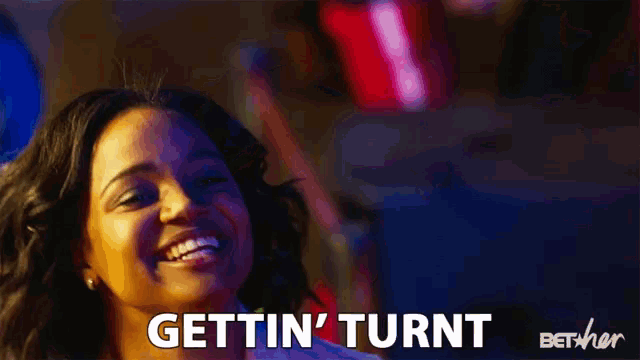 a woman is smiling with the words gettin ' turnt behind her