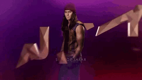 a man with long hair is standing in front of a purple background with the words son of jafar on it .