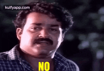 a man with a mustache is saying no .