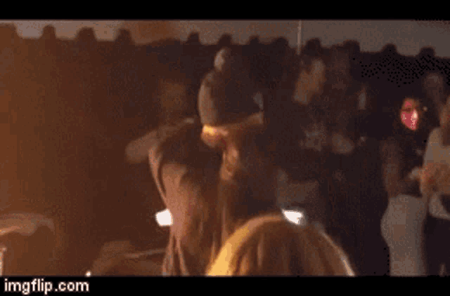 a group of people are dancing in a dark room with imgflip.com at the bottom of the screen