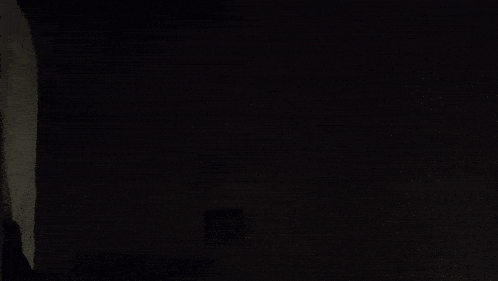 a blurred image of a person 's arm in the dark .