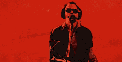 a man wearing headphones singing into a microphone with the words " yeah man " above him