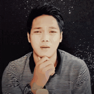 a man in a striped shirt has his hands on his chin