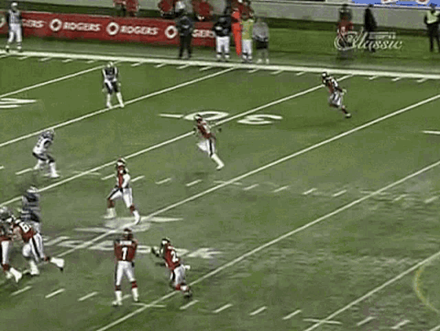 a football game is being played on a field that has espn advertisements on the sidelines
