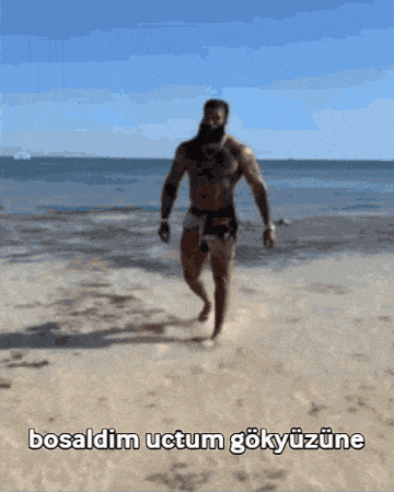 a man walking on a beach with the words bosaldim uctum gokyuzune