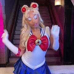 a woman in a sailor moon costume is standing in front of a set of stairs