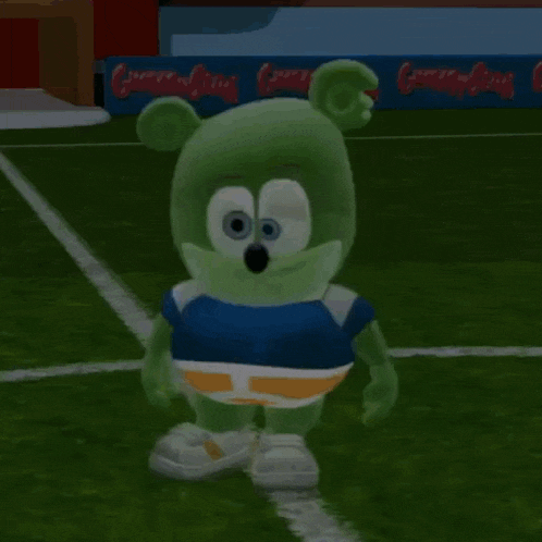 a gummy bear is kicking a soccer ball on the field