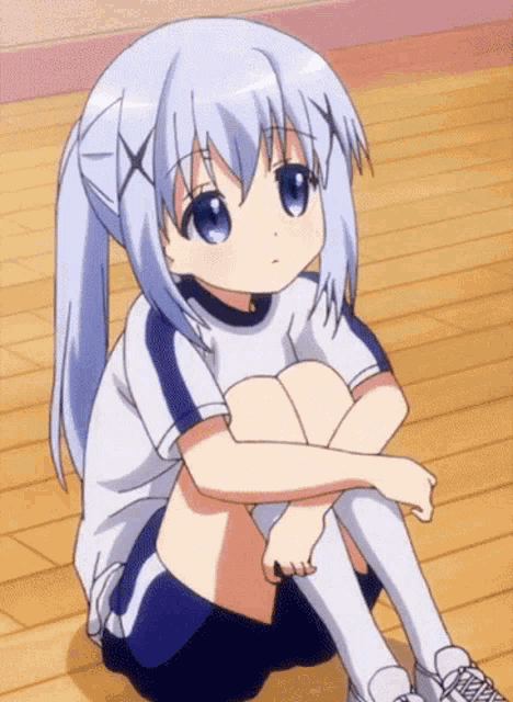 a girl with blue hair and blue eyes is sitting on the floor with her legs crossed