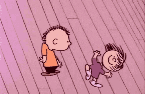 a boy and a girl are dancing on a pink wooden floor .